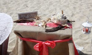 A table with a red bow and some other items on it.